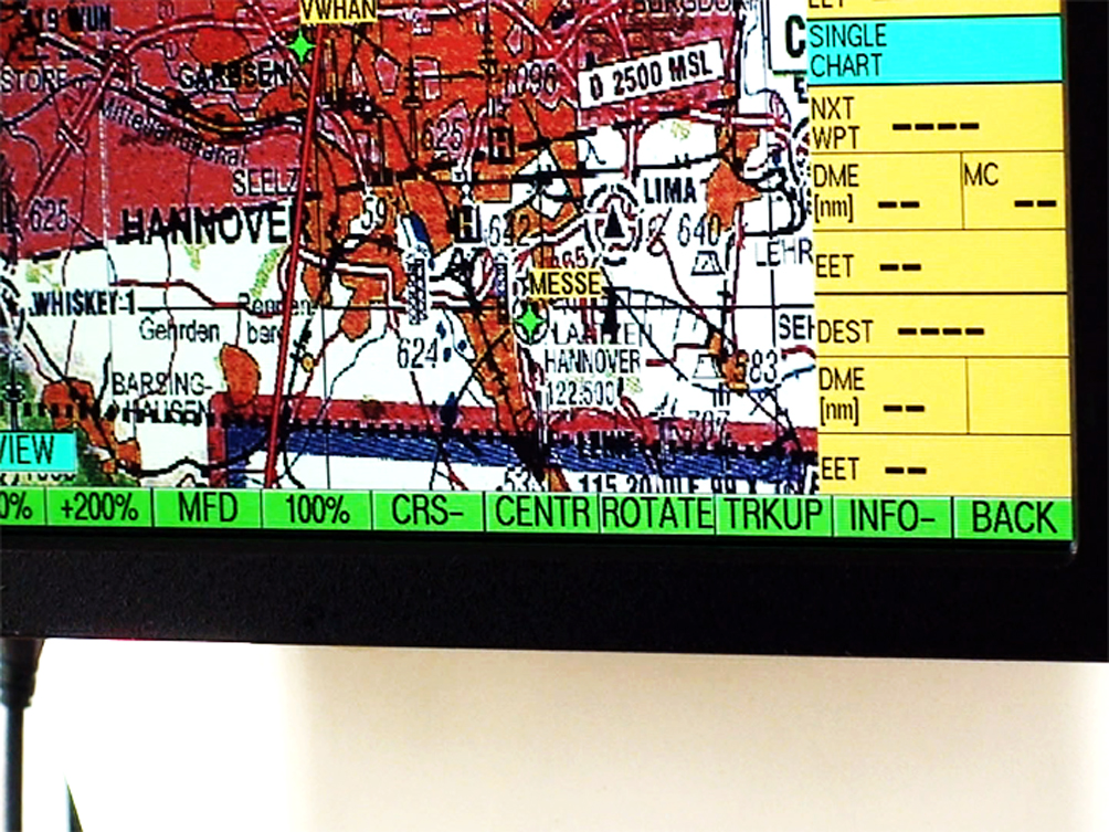 A Performer is flying in a Helicopter Bell 407 and looking at the exhibition from above for 2-3 minutes and then flying away.