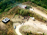 A Performer is flying in a Helicopter Bell 407 and looking at the exhibition from above for 2-3 minutes and then flying away.